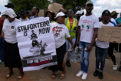 Rescuers bring out survivors and dead from a South African mine as hundreds remain trapped