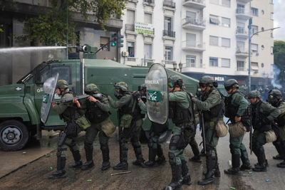 Argentine retirees and soccer fans clash with police during protests against austerity measures