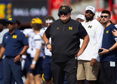 Biff Poggi tells signees and parents Michigan hopes to hire a coach by end of month, AP source says