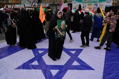 Iran commemorates 1979 revolution as nation is squeezed by anger over crackdown and tensions with US