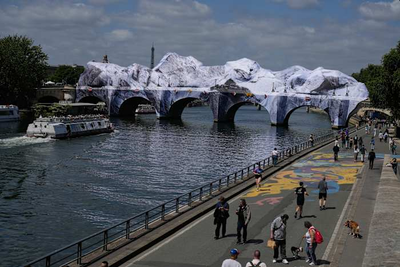 Artist JR, the 'French Banksy' creates a 'cave' installation over Paris' oldest bridge