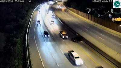 Vehicle narrowly avoids slamming into driver on side of Ohio highway, dramatic video shows