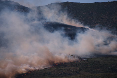 More than 200,000 people flee raging wildfires in France and Spain, some escaping by boat