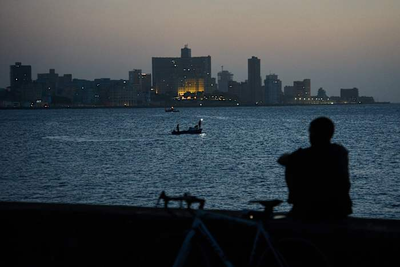 Cubans sleep on seaside boardwalk to seek relief from crippling blackouts and summer heat