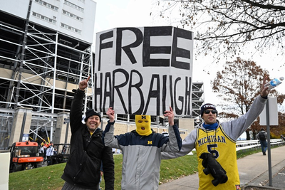 Michigan plays without coach Jim Harbaugh, beating Penn State after no court ruling to lift his ban