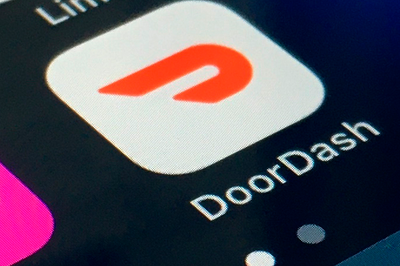 DoorDash orders surge 24% in the third quarter, helping to narrow the delivery app's losses