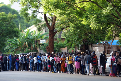 A Christmas rush to get passports to leave Zimbabwe is fed by economic gloom and a price hike