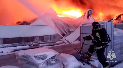 A huge fire engulfs a warehouse in Russia outside the city of St Petersburg