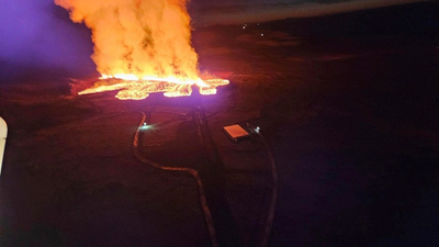 A volcano erupts in southwestern Iceland, sending lava flowing toward a nearby settlement