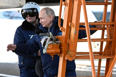 Putin takes a flight in nuclear-capable bomber in a tough message to the West ahead of election