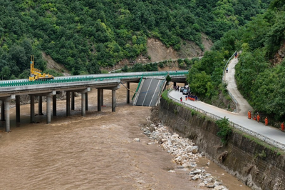 11 dead and dozens missing after a highway bridge in China crumbles in flooding and heavy storms