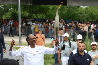 Snoop Dogg carries the Olympic torch before opening ceremony in Paris